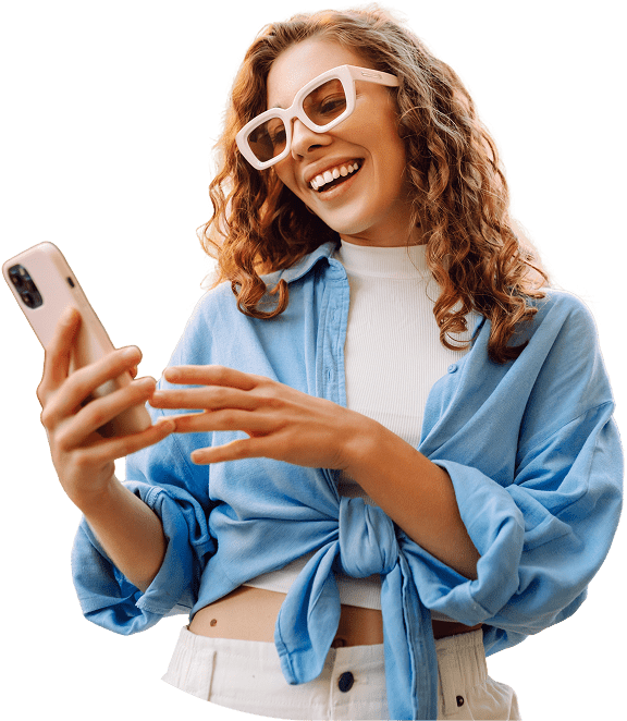 Woman smiling while using a smartphone.